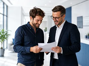Two men are standing in an office.